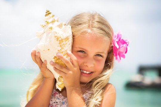 girl listening to a seashell