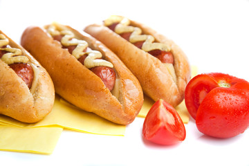 Three hot dogs with tomato