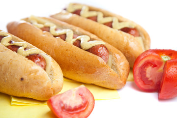 Three hot dogs with tomato