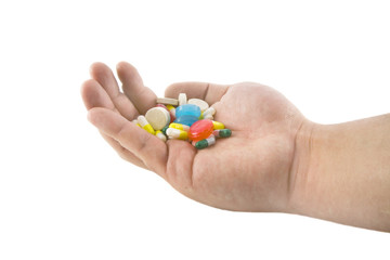 Hand with pills and tablets isolated on white background