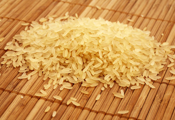 Rice on chinese bamboo mat, close up.