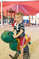 Boy playing on rocking horse at a park