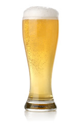 Glass of cold and fresh golden beer, over white background