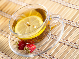 Tea with lemon fruit on bamboo background