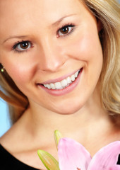 girl with flower smiling at camera