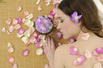 Spa resort –girl in rose petal with orchid