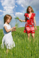 mother and daughter in green field