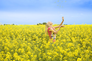 Naklejka na ściany i meble happy girl in a park with flowers