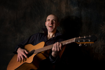 man playing acoustic guitar