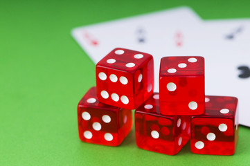 Red dice and cards at the green background