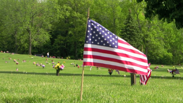US flags waving over veteran graves on Memorial Day