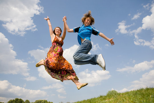 Girl and boy jumping