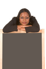 Friendly adult student leaning on chalk board