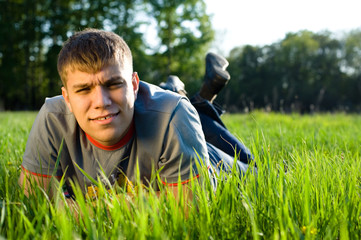 Fototapeta premium Portrait of man lying down of grass.