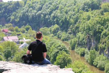 Sitting alone at the top of the precipice