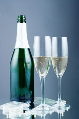 Two champagne glasses and champagne bottle