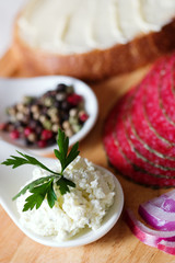 Salami slices with bread, cheese and spices