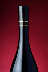 Close-up of a wine bottle on a red background