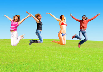Girls jump on a meadow