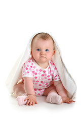 Cute baby sitting with towel on head isolated over white