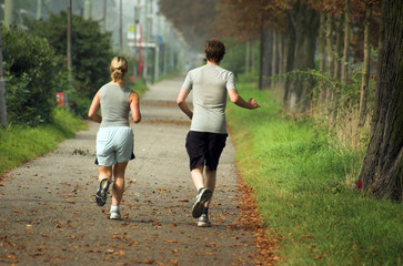 A couple running on a park