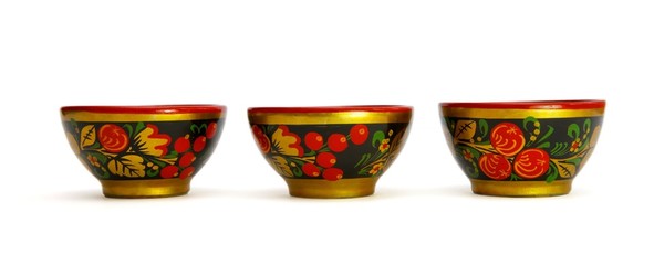 Three painted Russian khokhloma wooden cups isolated