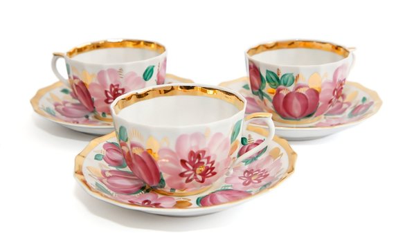 Three traditional tea cups with saucers isolated