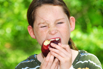 Young girl eating apple