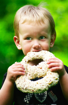 Boy Eating A Chocolate Pretzel