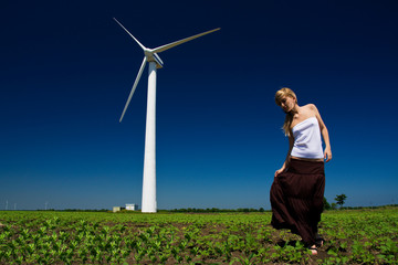 Fototapeta na wymiar Model posing in front of wind power generator