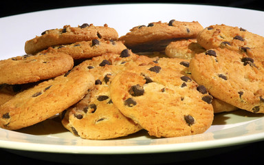 Choc chip cookies arranged on a white plate