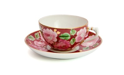 Tea cup and saucer with floral pattern isolated