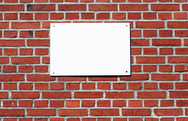 Fototapeta na wymiar blank sign on a brick wall