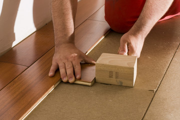 worker install a hardwood floor