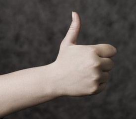 Thumbs up towards grey background