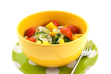 vegetable salad in a yellow bowl and fork