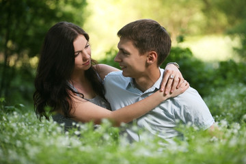 Fototapeta premium Couple sitting on the grass.