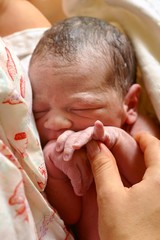 newborn baby in mother's arms two minutes after birth