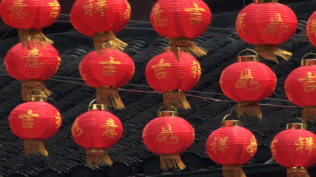 Chinese red paper lanterns swaying in the wind