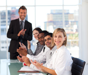 Senior leadership applauding in a meeting