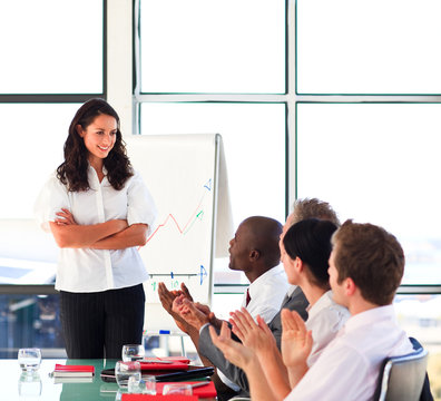 Brunette businesswoman interacting with her colleagues in a pres