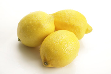 three lemons on white background