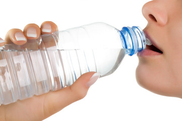 young girl with bottle of mineral water (isolated on white)