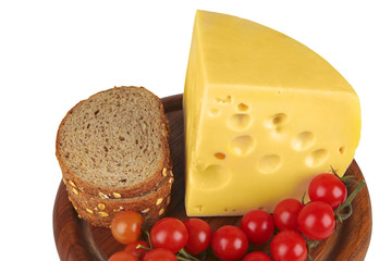 big chunk of yellow cheese with tomatoes and bread
