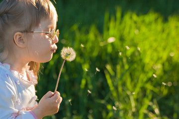 Little girl with dandelion shot