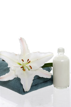 spa objects and flower Madonna lily over white