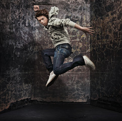 Fototapeta na wymiar Male dancer posing over grunge wall