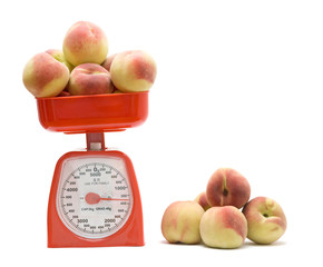 Red kitchen scale weighting peaches