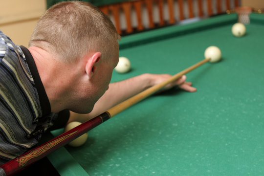 The Mid Adult Man At Play In Billiards