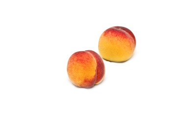 Two isolated peaches